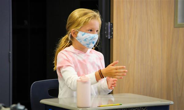 girl answers question from desk